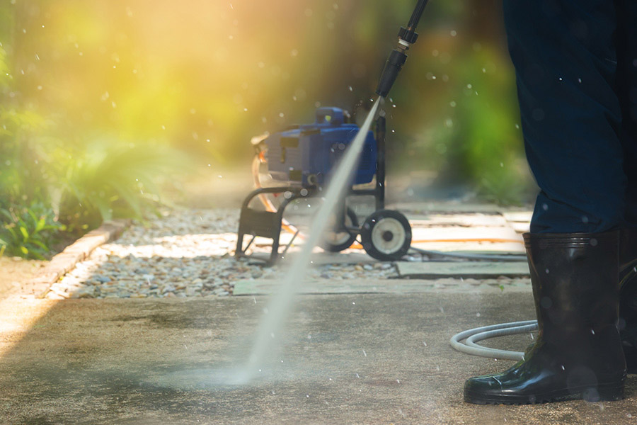pressure washing a concrete sidewalk